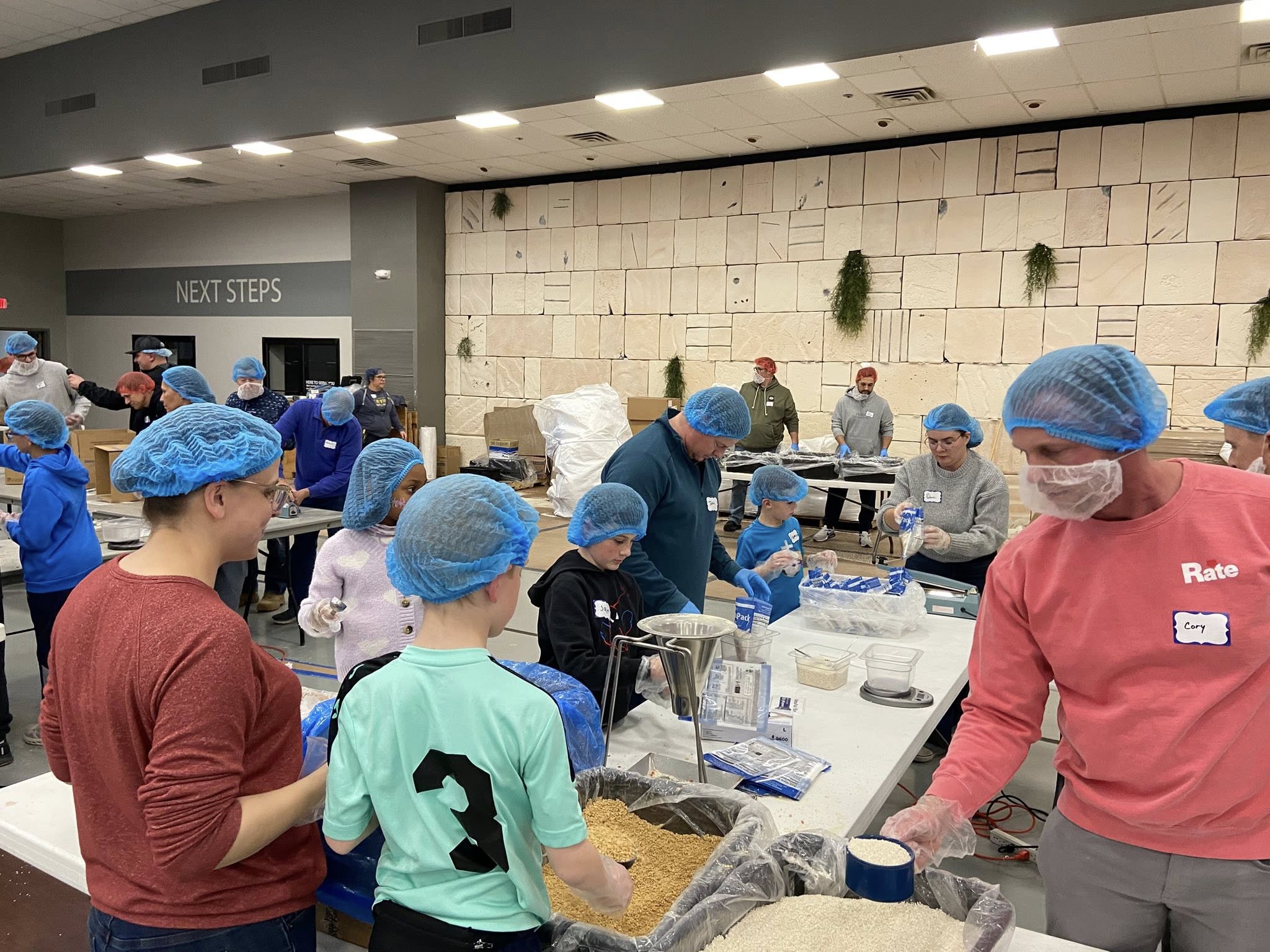 Elevate FC volunteers at community food packing event